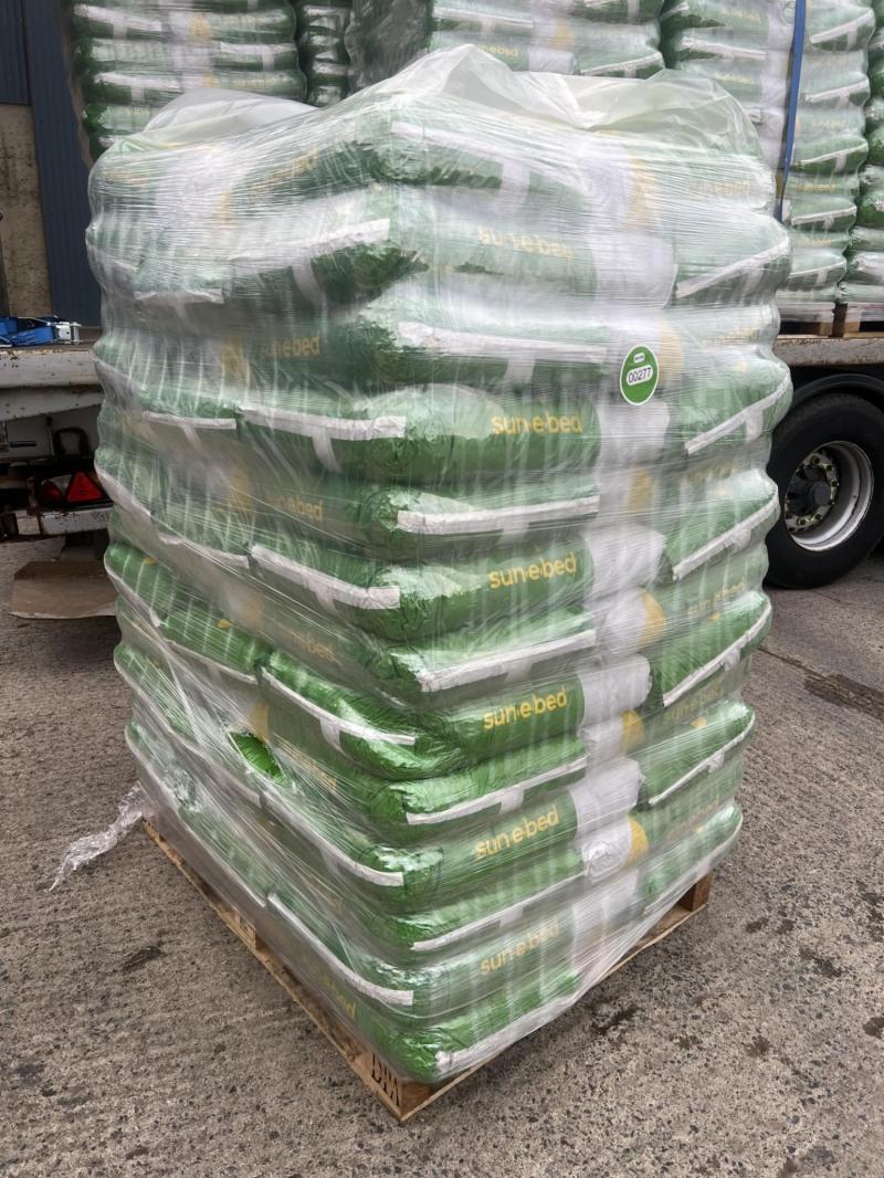 Stack of stacked bags with 'Sunflower' branding on a pallet.