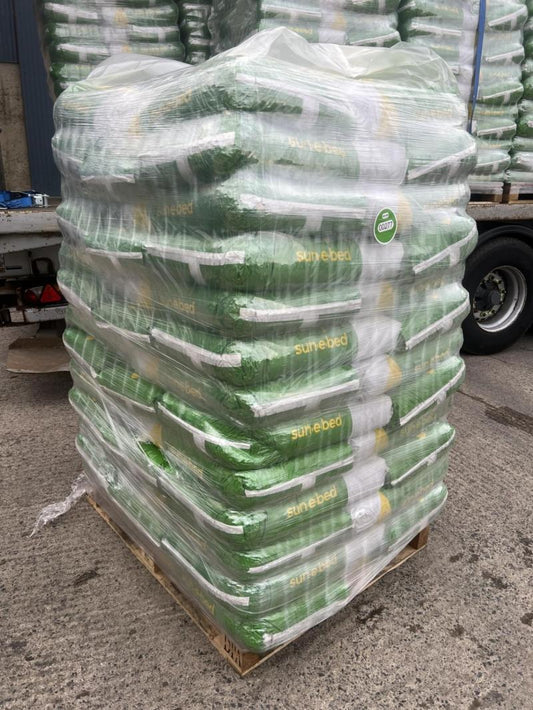 Stack of stacked bags with 'Sunflower' branding on a pallet.